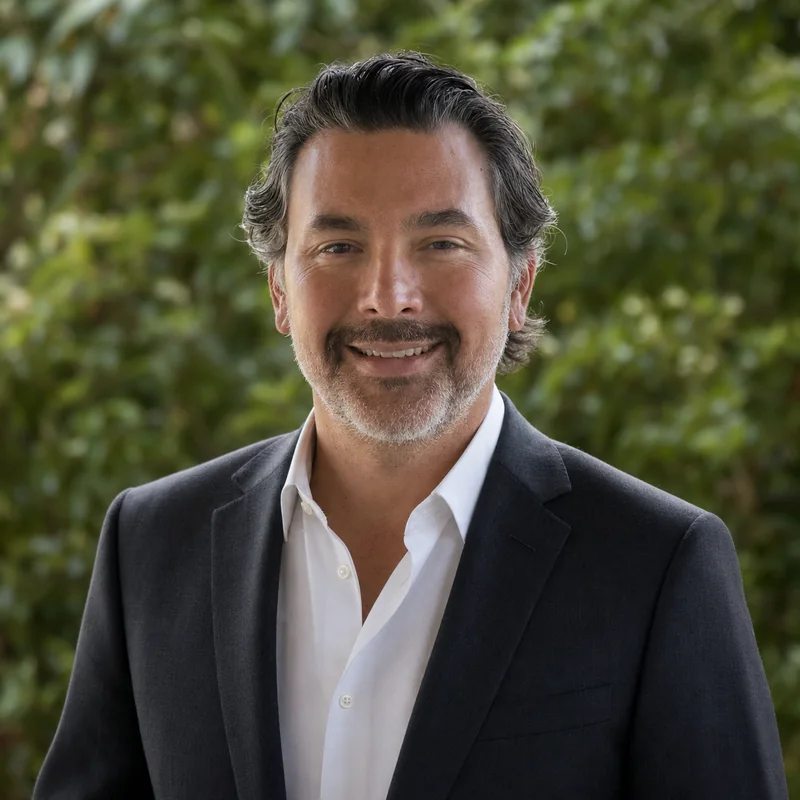 Jose Lopez wearing a dark jacket and white shirt outdoors